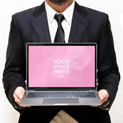 Mockup of A MacBook Held by a Man 